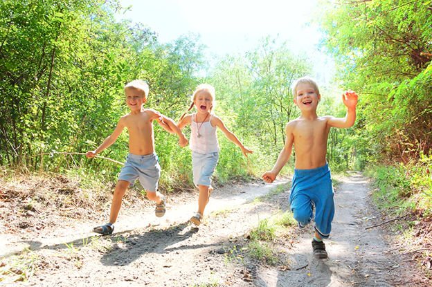 happy kids running in the woods