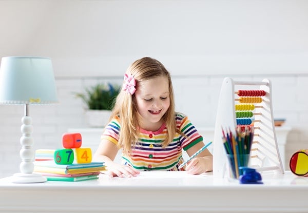 Young girl doing math at home