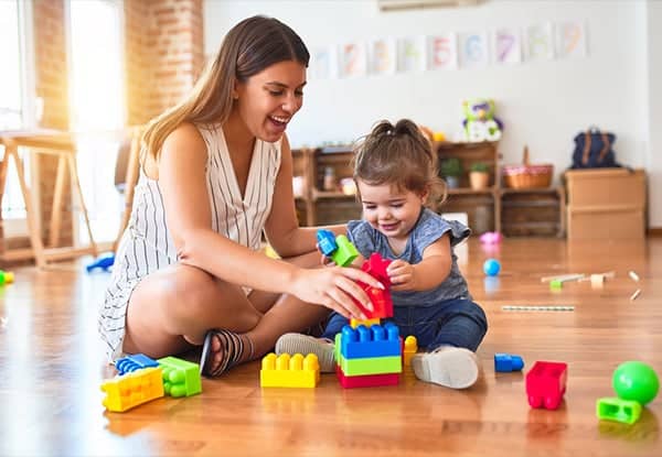 Mom playing with blocks with kid