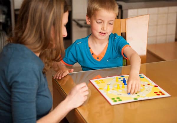 Mom playing a board game with son