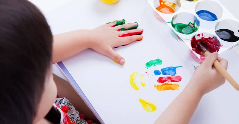 young kid painting to build confidence