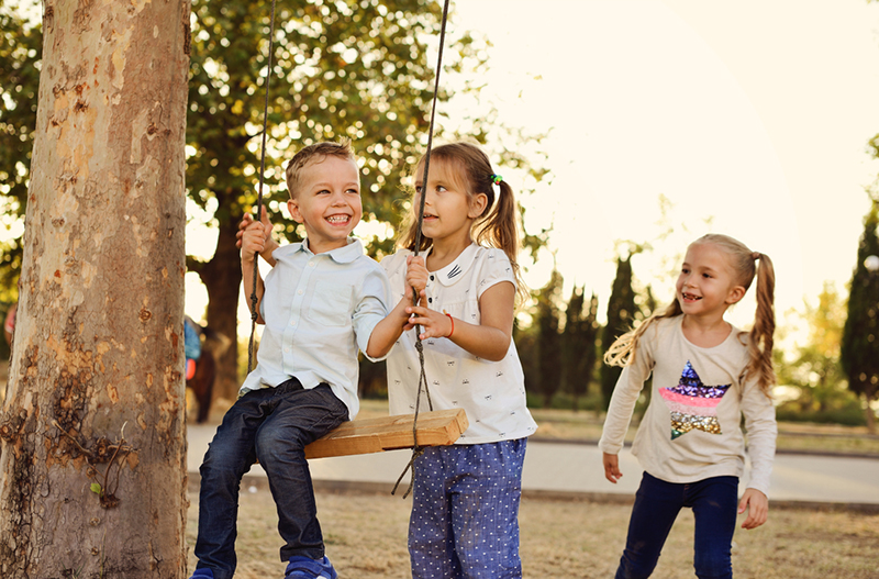 kids playing on swings outdoors