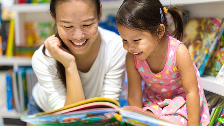 Mom teaching kid the letters in the alphabet
