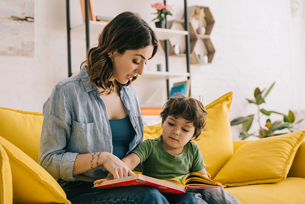 Mom helping son with kindergarten reading