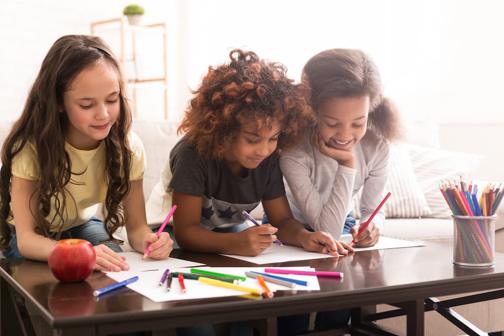 Kids playing art games drawing on a table