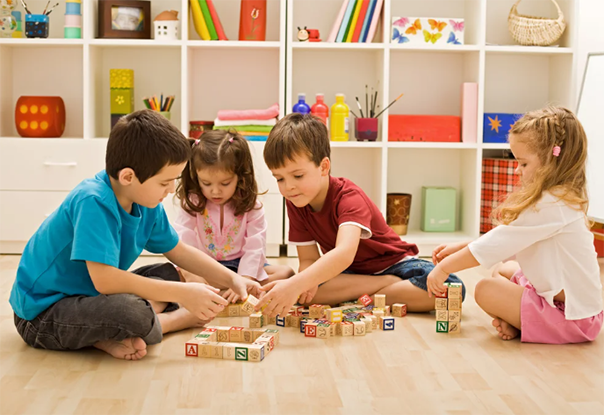 Kids learning through playing with blocks on the floor