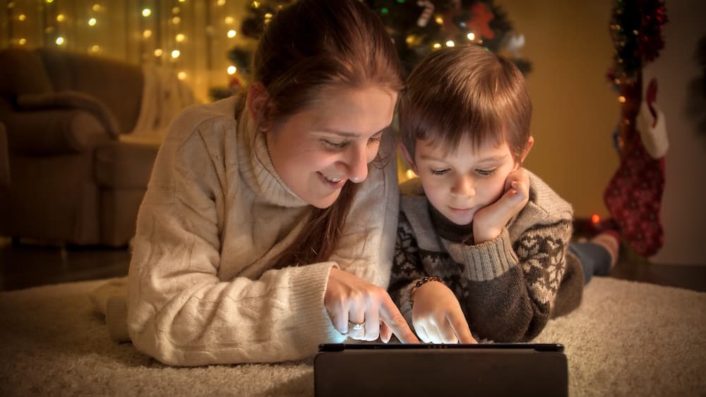 Holiday-screen-time-1 Mother and son enjoying screen time together during the holidays