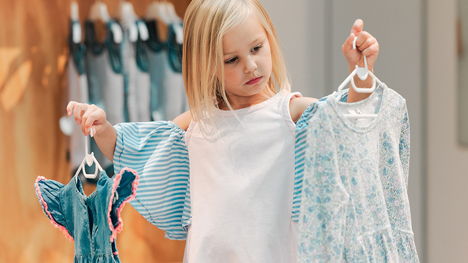 Child picking out her own outfit