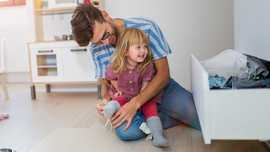 Father narrating as he puts socks on young child