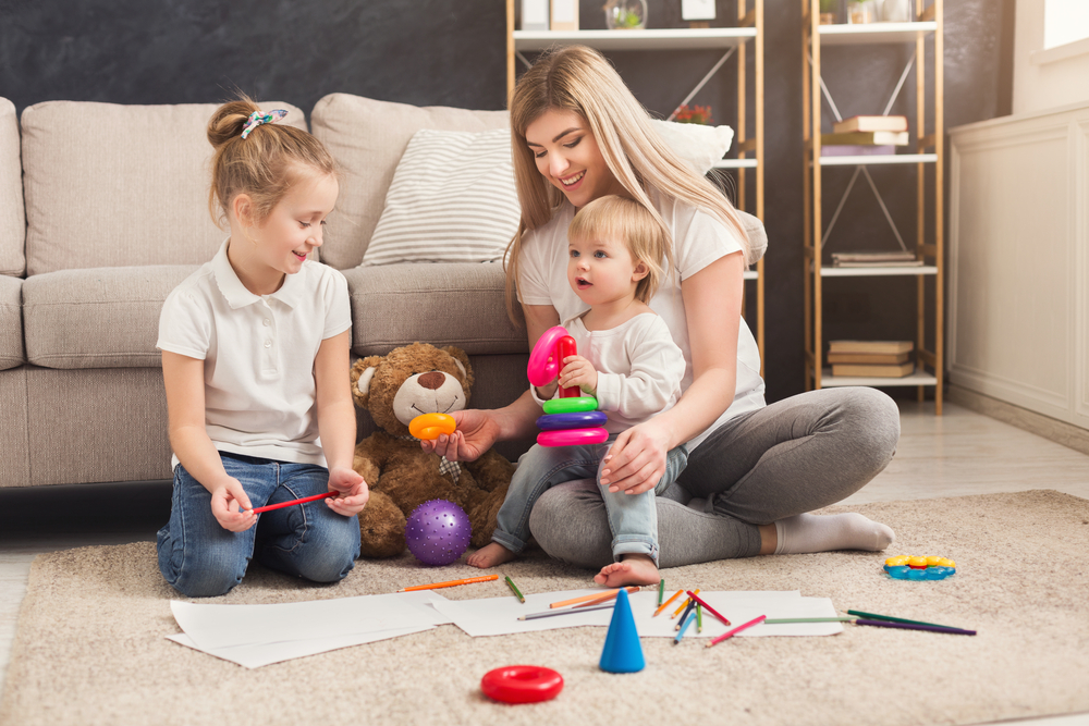 Mom with two kids teaching them how to follow directions