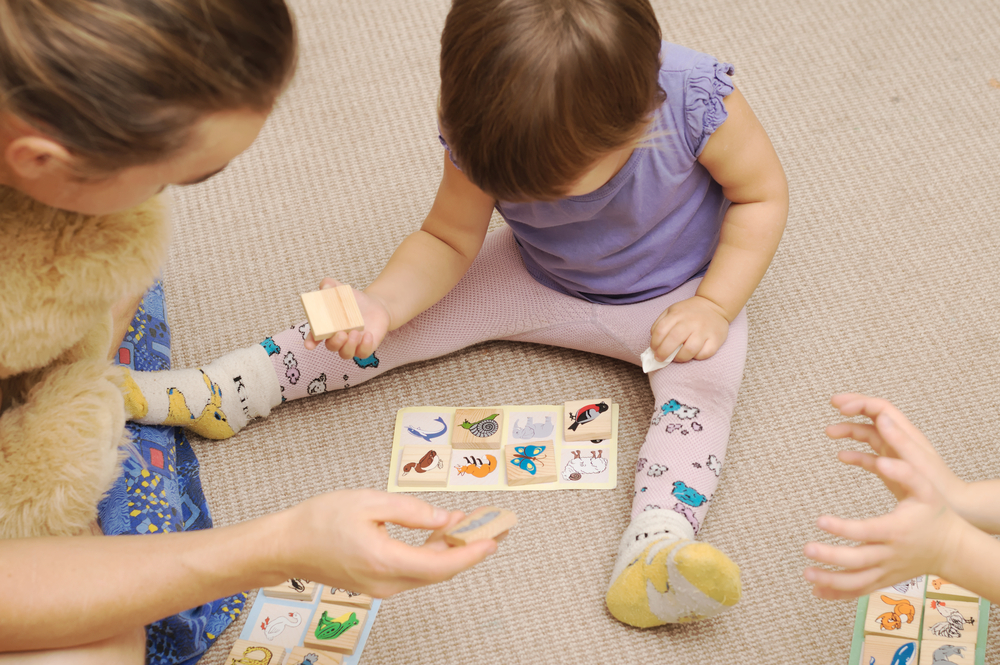 child using playing matching game to learn letter s