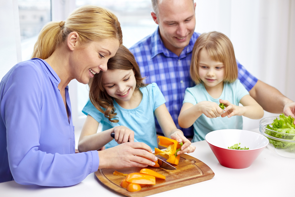 Parents cooking with their daughters