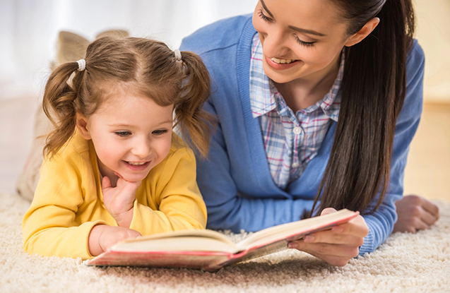 Young mother is reading a book to her cute daughter. Young mother is reading a book to her cute daughter.
