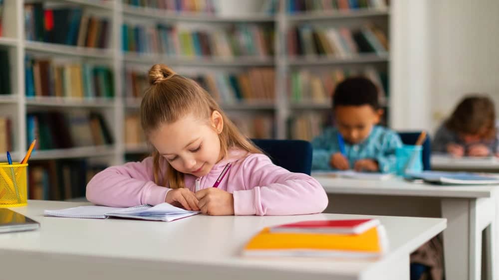 young girl studying spelling words